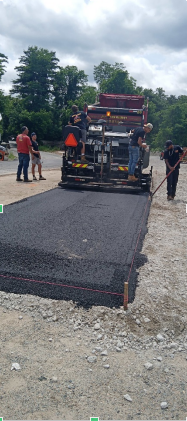 Paving contractors from Asphalt Paving by J. A. Cooper paving a road