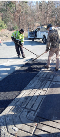 Asphalt paving contractors working on a road