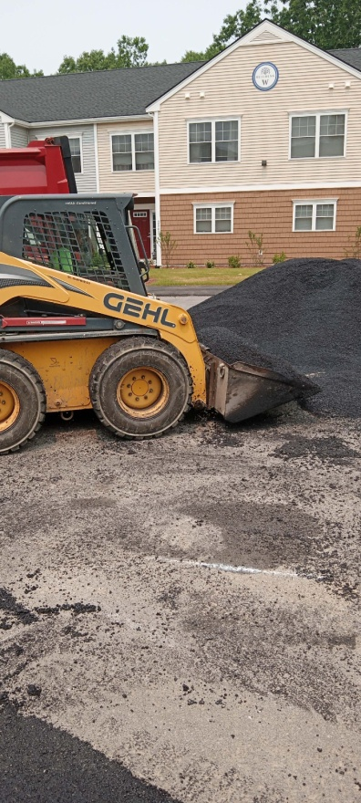 An asphalt driveway installation for a residential property