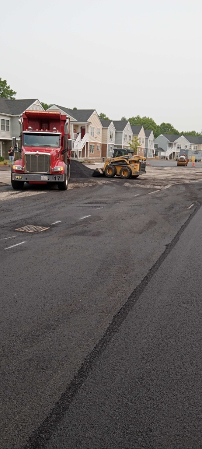 Contractors from asphalt paving company working on a road