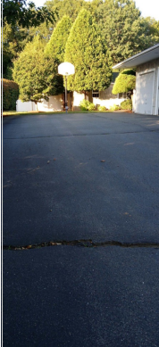 a freshly paved driveway with asphalt
