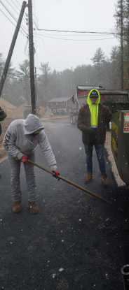 Paving contractors working on a driveway in winter