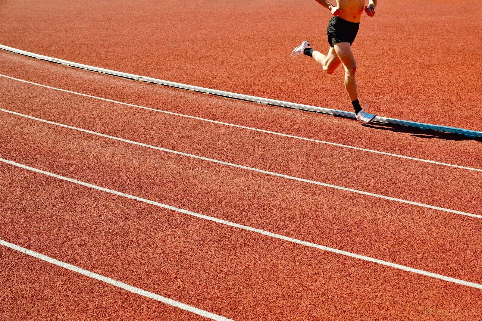 A person running on a leveled track